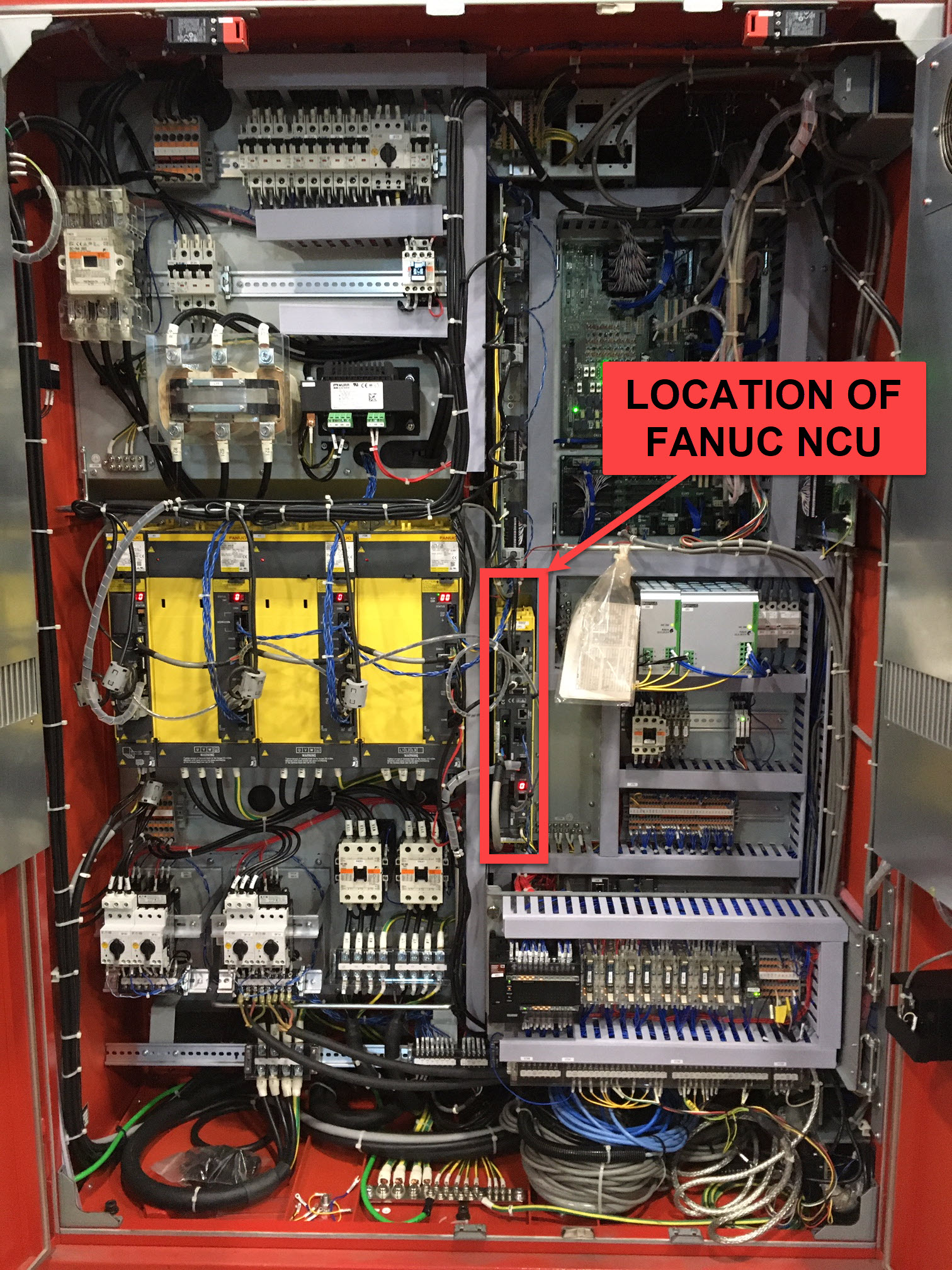 Amada electrical cabinet interior — FANUC NCU (FOCAS NIC) location highlighted in red box on the right side of the cabinet; yellow FANUC servo drives visible on the left