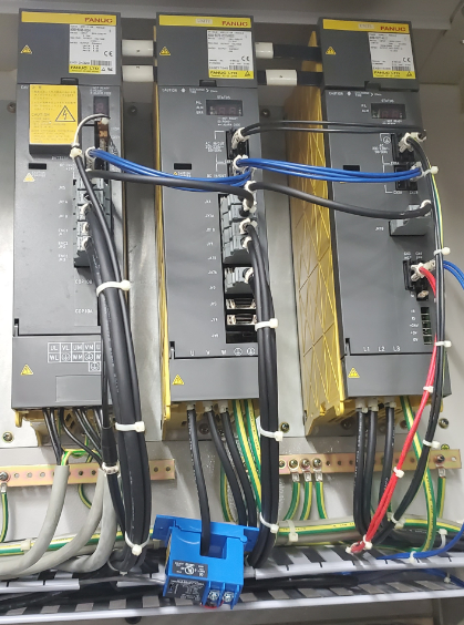 CT installed on FANUC spindle drive power cables — sensor secured at the base of the drive unit